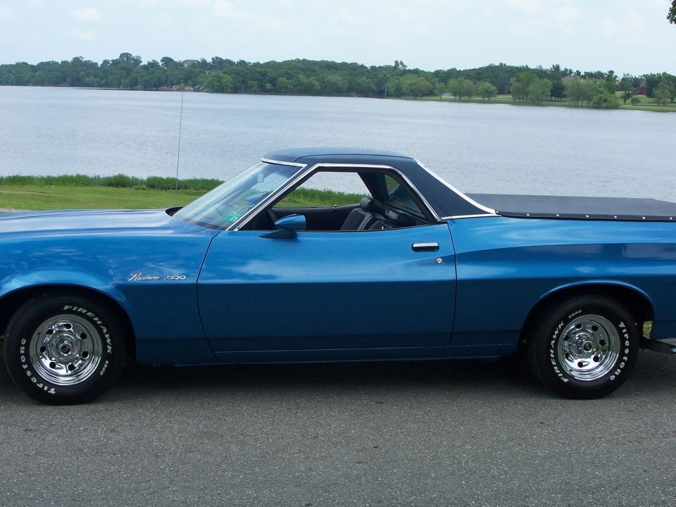 Blue 1973 Ford Ranchero side view with a black vinyl top