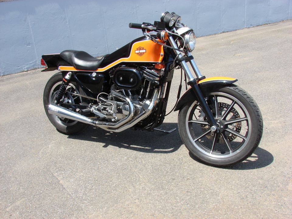Orange and black Harley-Davidson Sportster motorcycle, 3q-front view