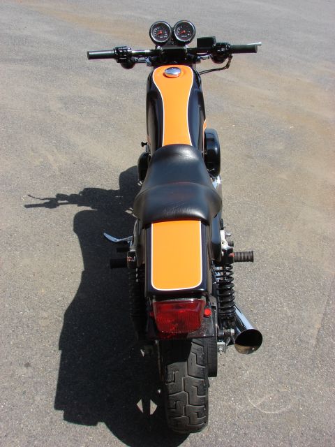 1993 Jeep YJ - Motorcycle rear view with black and orange paint scheme and dual exhaust pipe.