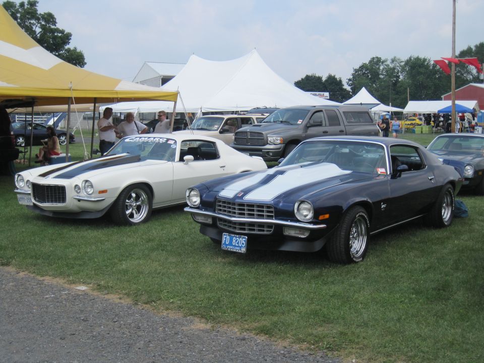 Blue 1970s Camaro with white stripes, front 3/4 view. License plate reads FD 8205