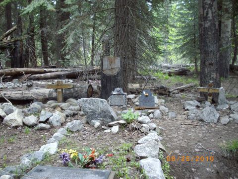 1982 Toyota 4Runner - A remote gravesite marked by stones and crosses, set amongst trees in a forest.