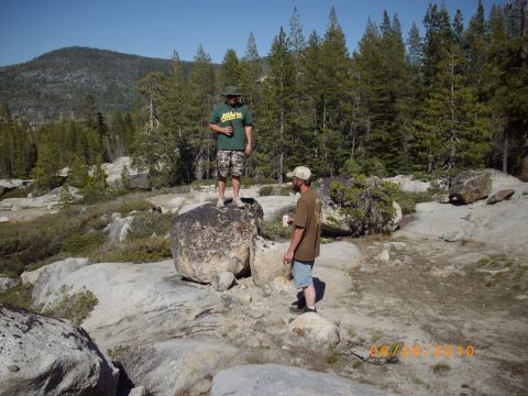 1982 Toyota Pickup/SR5 - Two men enjoy a break in a rocky, forested area on a sunny day.