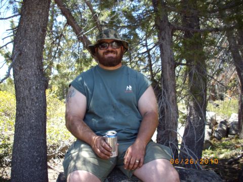 1982 Toyota Pickup/SR5 - A man enjoys a beverage outdoors, surrounded by trees and rocks. The date 06/26/2010 is visible in the lower right corner.