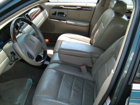 1988 Mercury Grand Marquis - Interior view shows leather seats, wood trim, and the steering wheel of a car.
