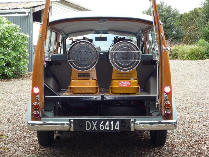 Rear view of a station wagon with two yellow portable heaters inside