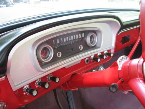 1966 Ford F-100 - The dashboard of a 1966 Ford F-100, a restored interior with a prominent speedometer and fuel gauge.