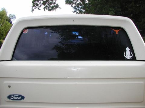 1990 Ford Bronco - Rear window stickers, showing support for the National Rifle Association, the University of Texas Longhorns, and all things squid.
