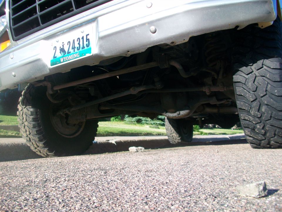 Underside of a 1980s Ford Bronco, showing suspension and front tire