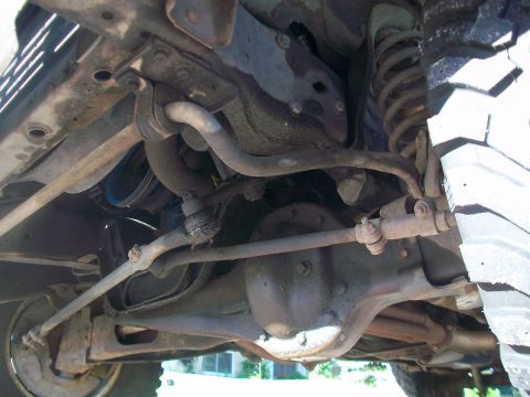 1986 Ford Bronco - Undercarriage view of a 1986 Ford Bronco, highlighting its suspension and drivetrain.