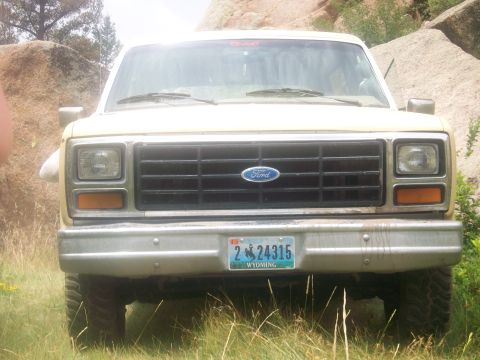 1986 Ford Bronco - This Ford Bronco is parked outdoors with a rocky landscape in the background.