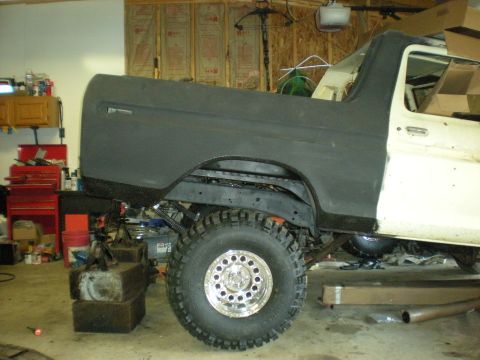 1978 Ford Bronco - This 1978 Ford Bronco is undergoing restoration, showing its side profile with a freshly primed rear quarter panel.