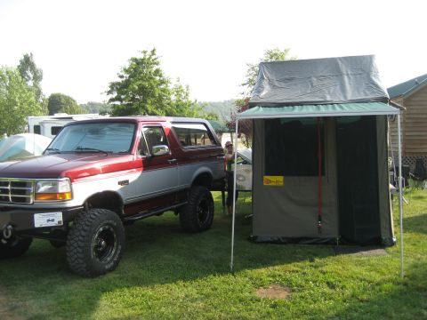 1996 Ford Bronco - 1996 Ford Bronco with a rooftop tent, set up for camping.