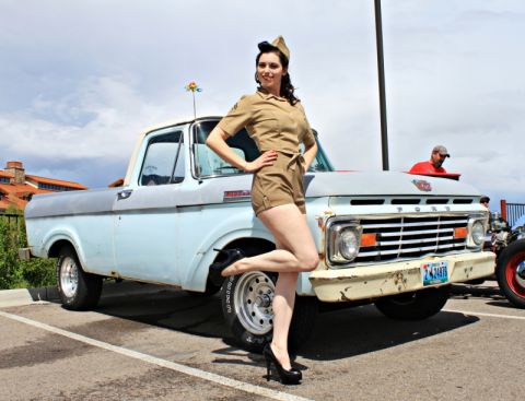 1963 Ford F-100 - A pin-up model poses next to a classic Ford pickup truck, which appears to be from the mid-1960s.