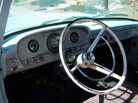 1963 Ford F-100 - The dashboard and steering wheel of a 1963 Ford F-100, showing its classic interior design.