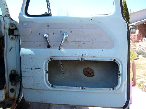 1963 Ford F-100 - The interior of a truck door is visible, with a person standing behind it.