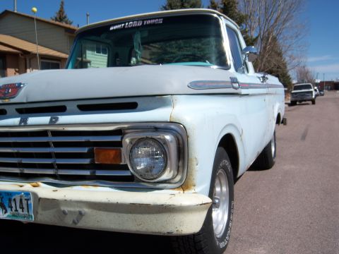 1963 Ford F-100 - Front view of a 1963 Ford F-100 pickup truck, showing its distinctive grille and bumper design.