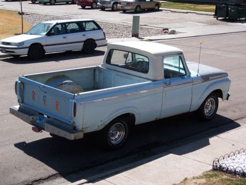 1963 Ford F-100 - This light blue 1963 Ford F-100 pickup truck is seen from a 3/4 front angle.
