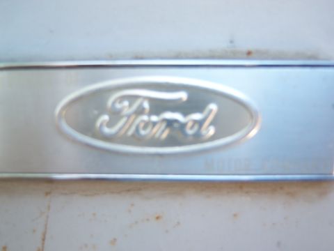 1963 Ford F-100 - Close-up of a Ford oval emblem on a metal surface.