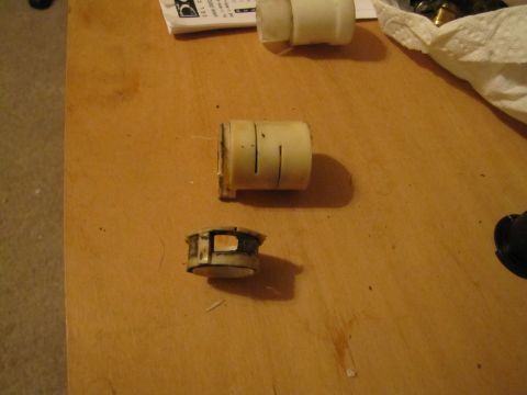 1993 Ford F-250 - These are two plastic parts, likely for a vehicle's clutch linkage system, laid out on a table.