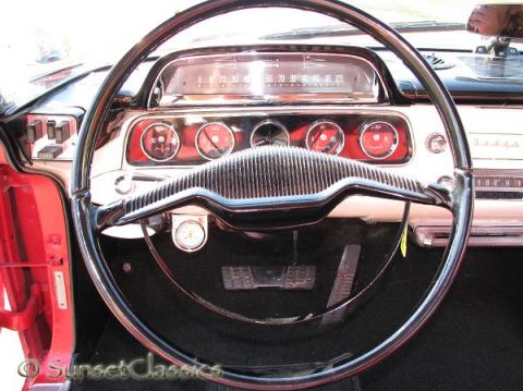 1991 Ford Crown Victoria - The interior of a classic automobile showcases its dashboard with multiple gauges and a large steering wheel.