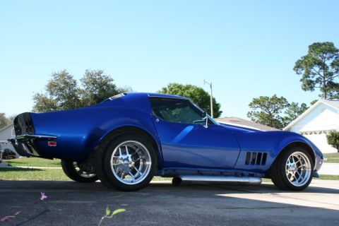 1976 Chevrolet Corvette - A blue 1976 Chevrolet Corvette is parked outside on a sunny day.