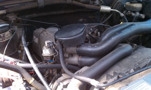 1992 Ford Bronco - Close-up view of an engine bay, showing various hoses and mechanical parts.