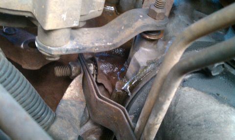 1992 Ford Bronco - This image shows a close-up view of engine components, with visible fluid leakage around some metal parts.
