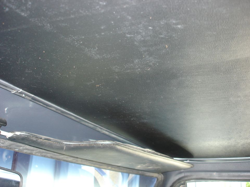 Interior shot of a vehicle's headliner and sun visor. Text on the bottom right reads SUPERMOTORS