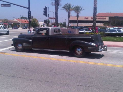 1986 Ford Bronco - This vintage pickup truck, likely from the 1940s, is seen driving on a sunny day.