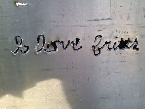 1990 Ford Bronco - Metal plate with carved text 'I love frits' visible.
