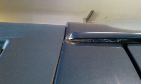 1992 Ford Bronco - Detail of a roof rack attachment point on a vehicle's body panel.