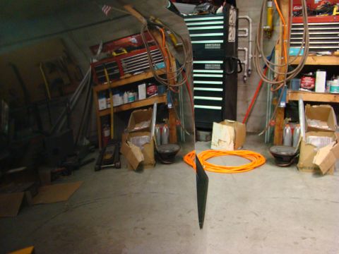 1948 Jeep Wrangler - A cluttered garage scene with various tools, storage, and supplies visible.