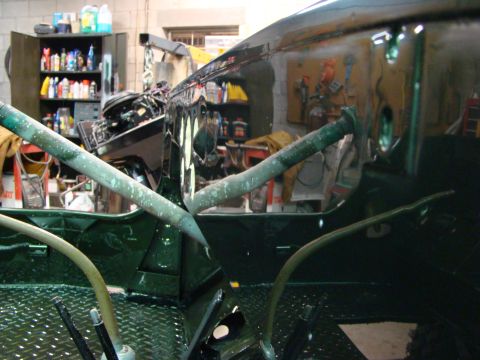 1948 Jeep Wrangler - The interior of a Jeep CJ-5, likely undergoing restoration or modification, with a roll bar and dashboard visible.