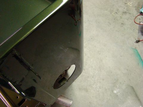 1948 Jeep Wrangler - Close-up of a green vehicle body panel, showing a circular cutout and some of the interior structure.