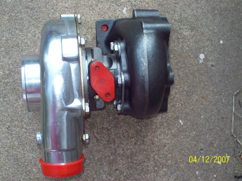 1995 Ford Probe - Turbocharger unit with polished and black housings, and red protective caps.