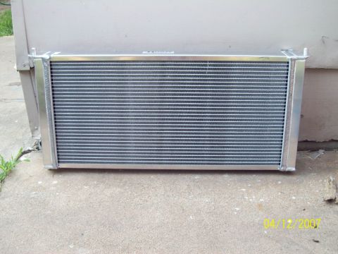 1995 Ford Probe - Radiator part shown outdoors on a concrete surface with a wall in the background.