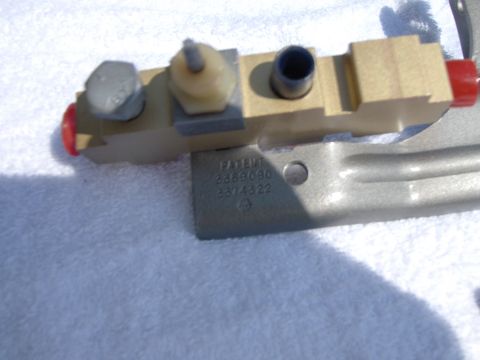 1970 Chevrolet Camaro - A close-up view of a brake proportioning valve with visible patent numbers stamped on its mounting bracket.