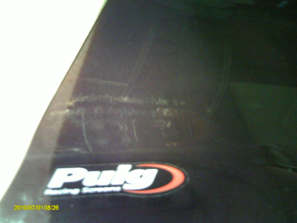 Puig Racing Screens logo on a dark, possibly scratched surface