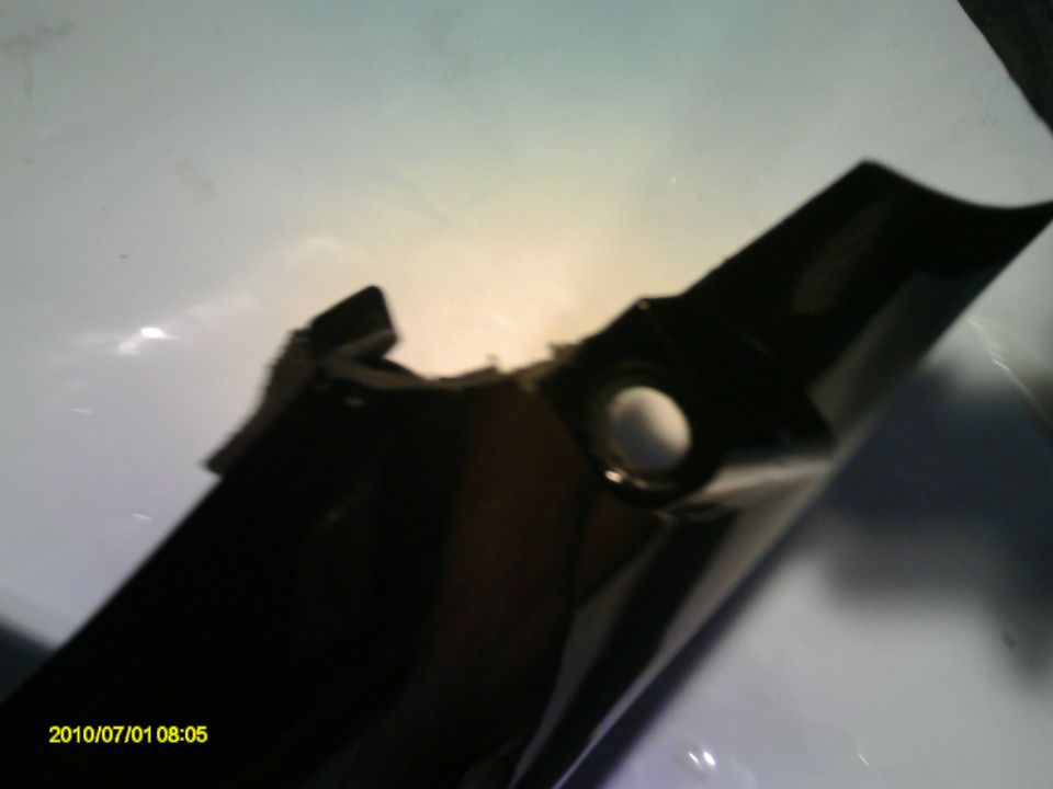 black plastic automotive part with a circular opening