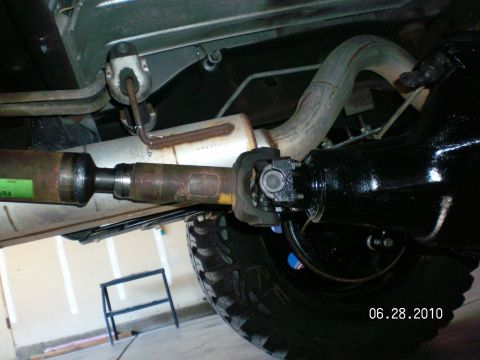 1996 Ford Bronco - Close-up view of the driveshaft and differential assembly, with part of the exhaust system visible.