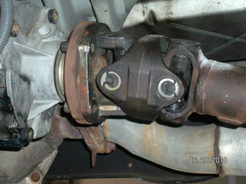 1996 Ford Bronco - Underside view of a vehicle's drivetrain components, focusing on the driveshaft connection.