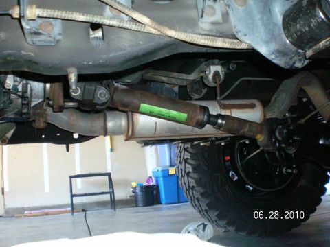 1996 Ford Bronco - Underside view of a vehicle's driveshaft and exhaust system, showing mechanical components.