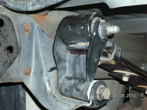 1996 Ford Bronco - This photo shows a close-up view of a vehicle's driveshaft mount bracket, including bolts and a rubber bushing.