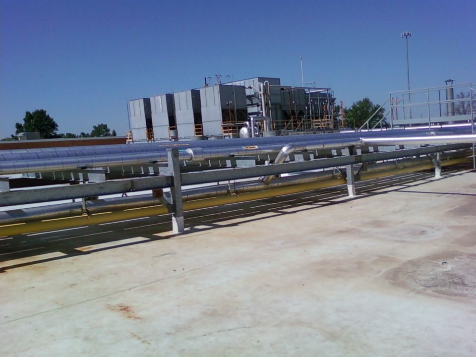 industrial cooling towers and pipes on a rooftop