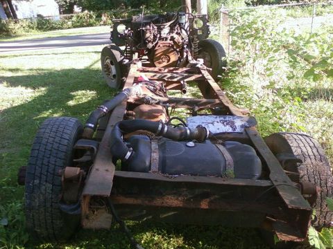 1989 Ford Bronco - This is a disassembled truck chassis with its engine and fuel tank visible.