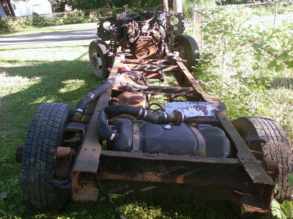 Truck chassis with engine and fuel tank, viewed from the rear