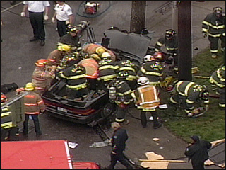 1990 Ford Bronco - Emergency responders are on the scene of a car accident, working to free a trapped individual.