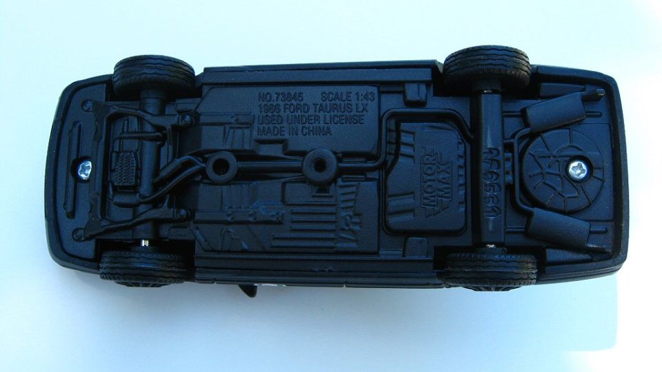 Underside of black diecast car marked No. 73845 1986 Ford Taurus LX