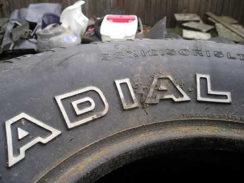 1990 Toyota Pickup/SR5 - A close-up view of a tire's sidewall shows raised lettering and size information.