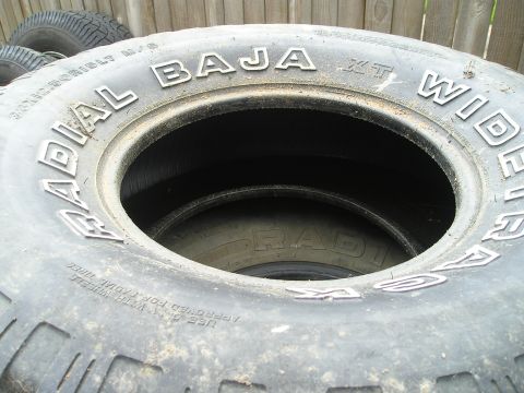 1990 Toyota Pickup/SR5 - Several tires are stacked, with the closest one showing raised white lettering.
